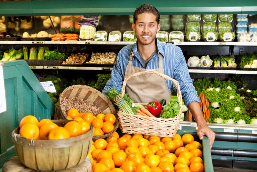 Supermarket assistant happy in the workplace